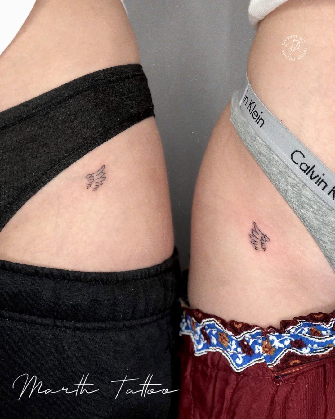 Matching small wing tattoos on twin sisters Tattoo Design