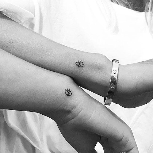 Minimalist twin eye tattoos on wrists Tattoo Design