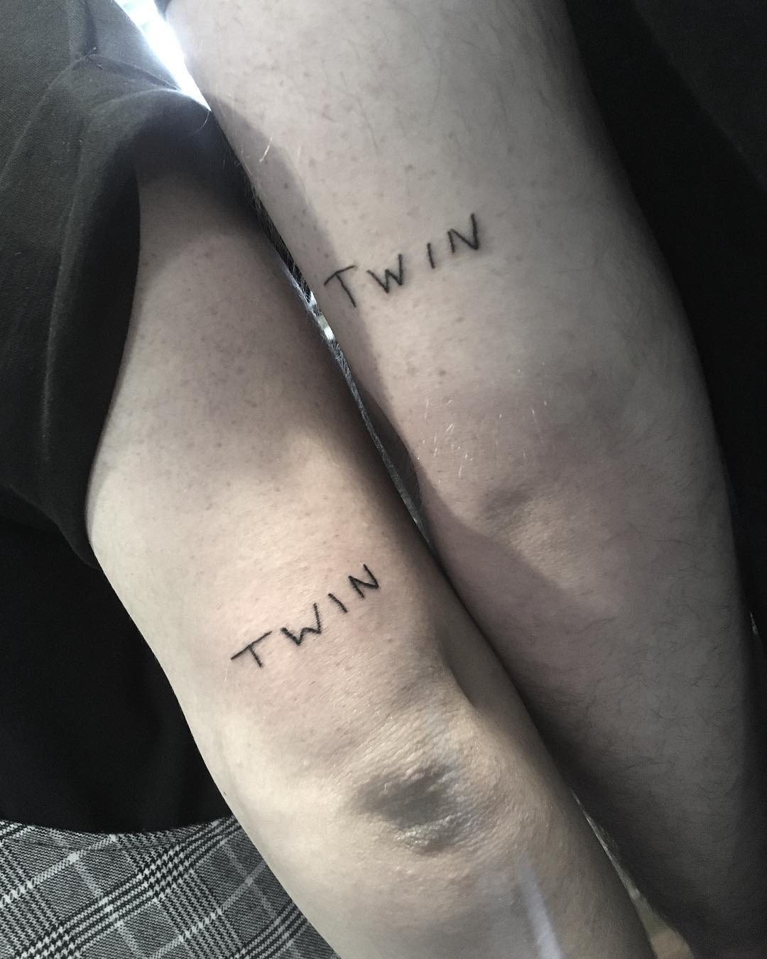 Minimalist twin tattoos in black ink Tattoo Design