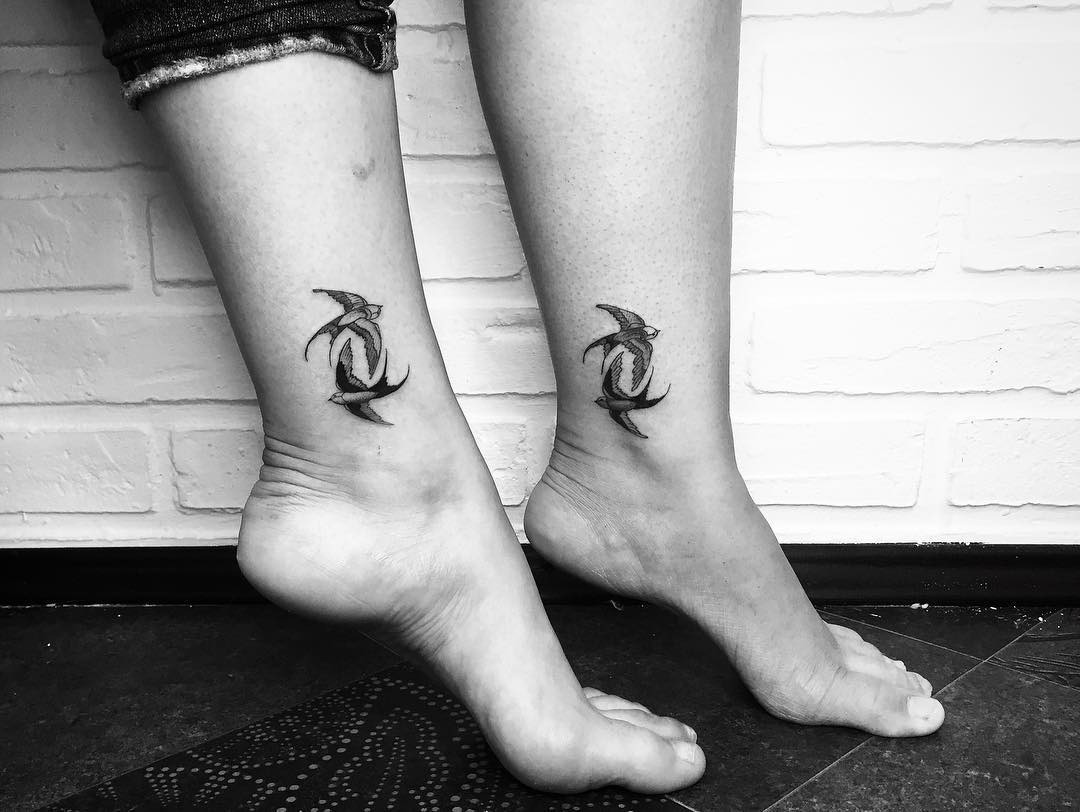 Symbolic twin bird tattoos on ankles Tattoo Design