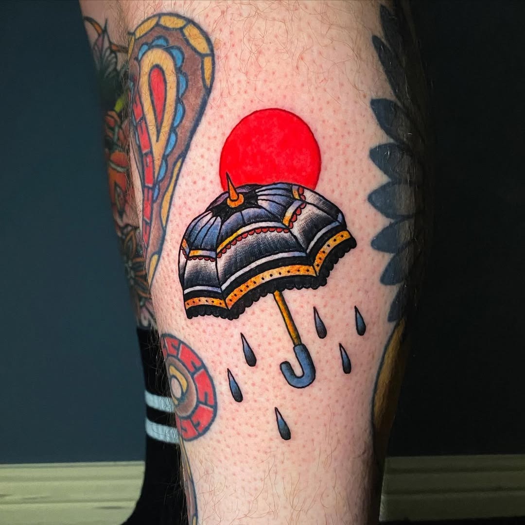 Bold umbrella tattoo with a vibrant sun backdrop Tattoo Design