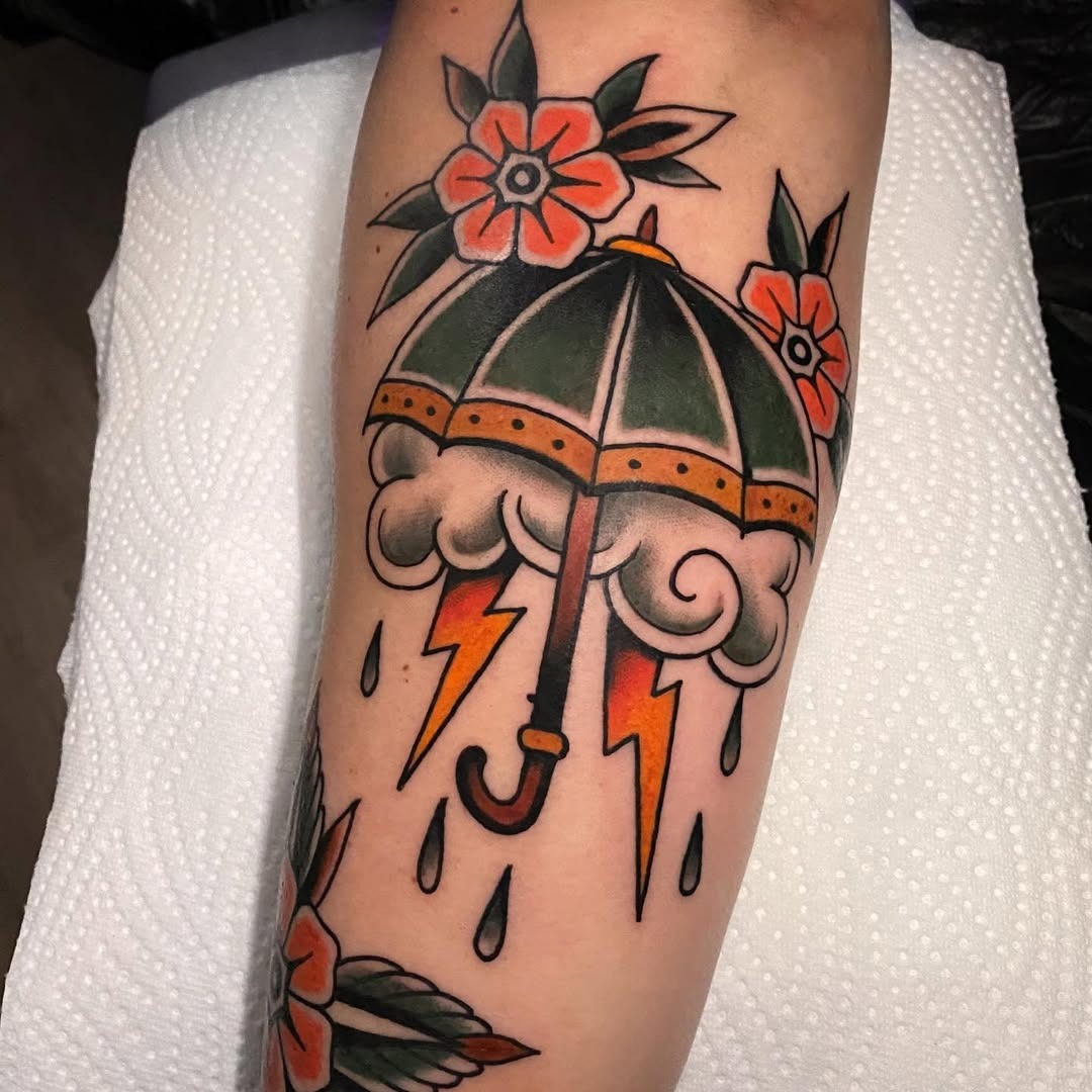 Vibrant umbrella tattoo with floral accents Tattoo Design
