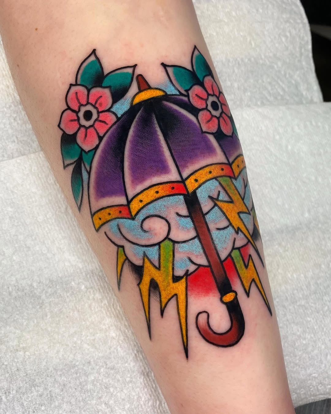 Vibrant umbrella tattoo with floral elements Tattoo Design