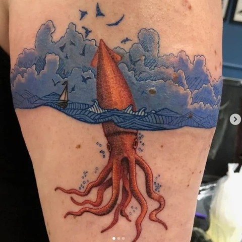 Playful Giant Squid Emerging from the Ocean Tattoo Design