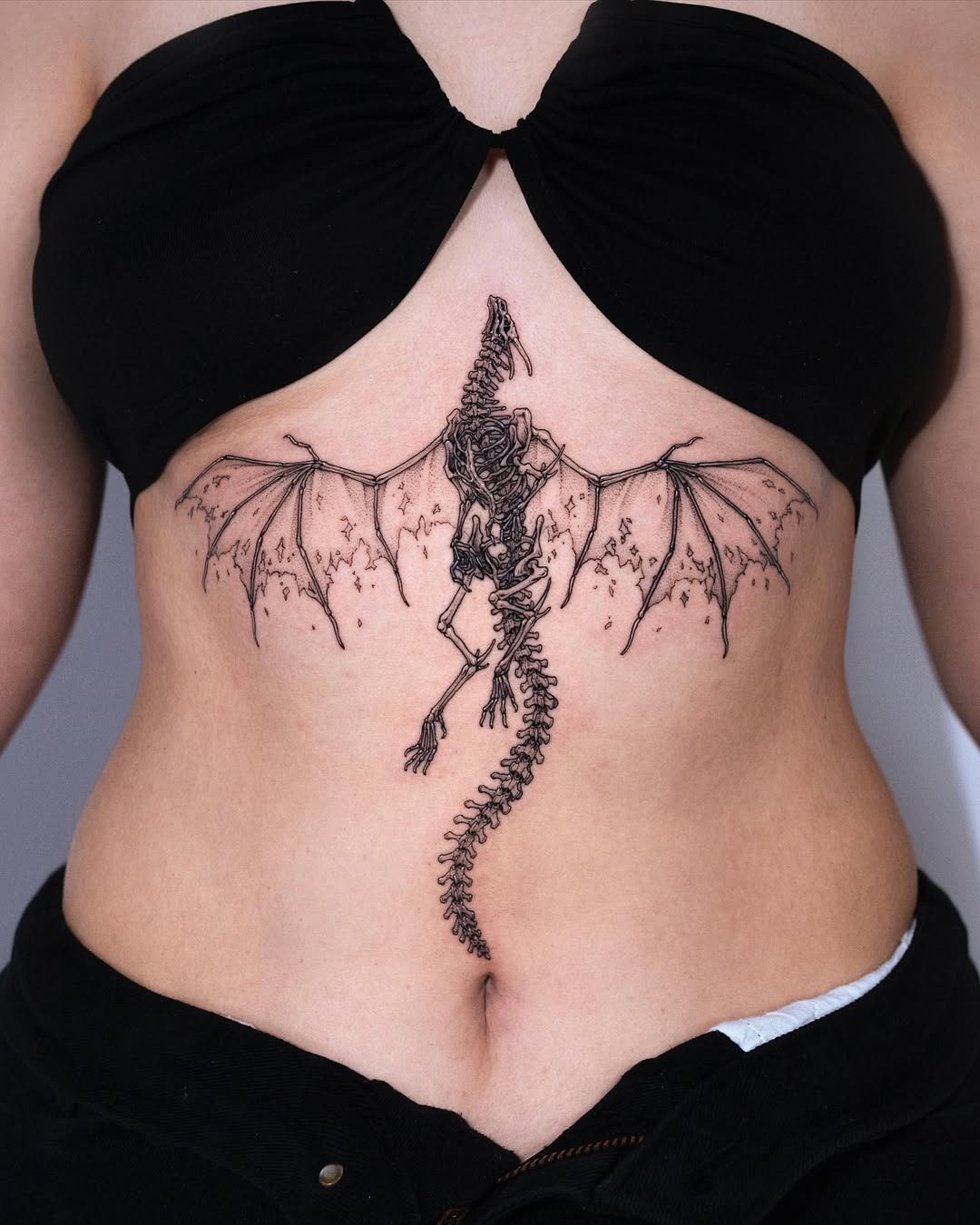 A stunning dragon skeleton underboob tattoo Tattoo Design
