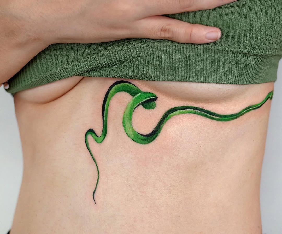 Captivating green snake underboob tattoo design Tattoo Design