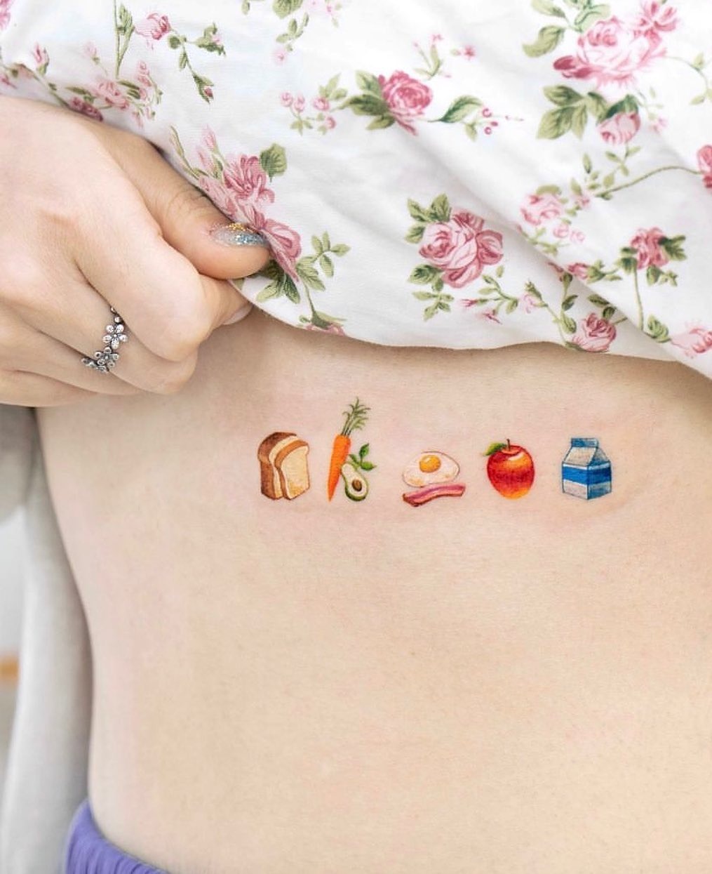 Colorful food-themed underboob tattoo design Tattoo Design