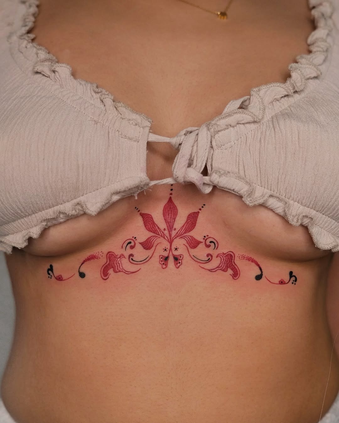 Elegant floral design under the bust area Tattoo Design