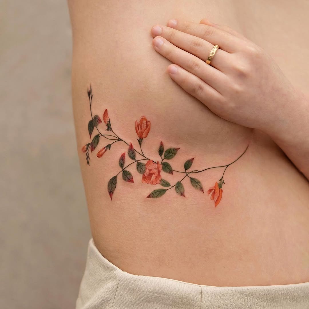 Elegant floral underboob tattoo design and placement Tattoo Design