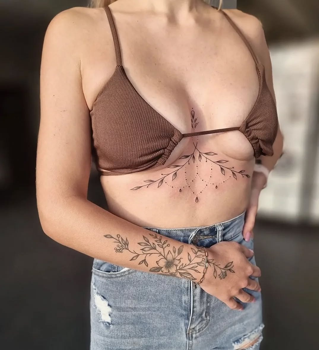 Elegant Floral Underboob Tattoo with Arm Accent Tattoo Design
