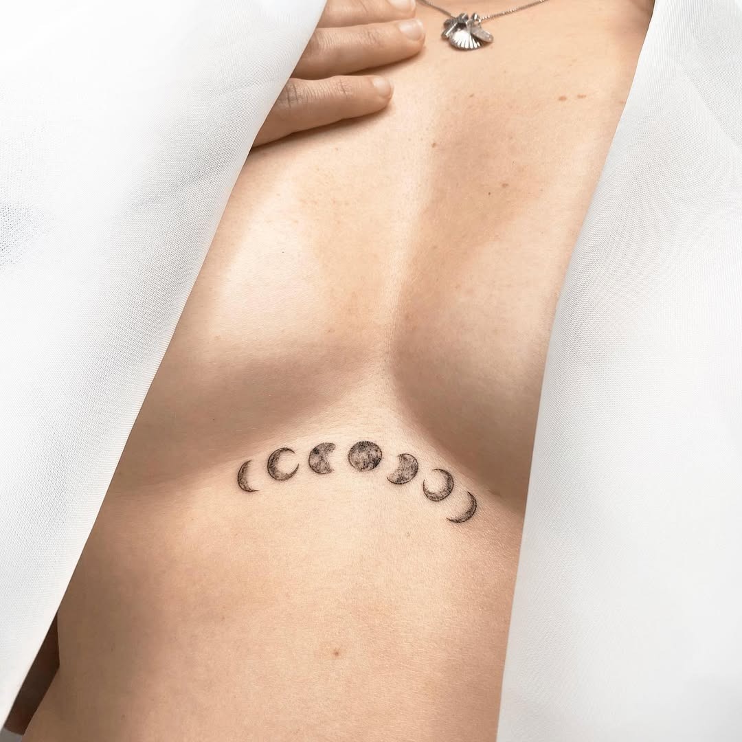 Elegant moon phase underboob tattoo design Tattoo Design