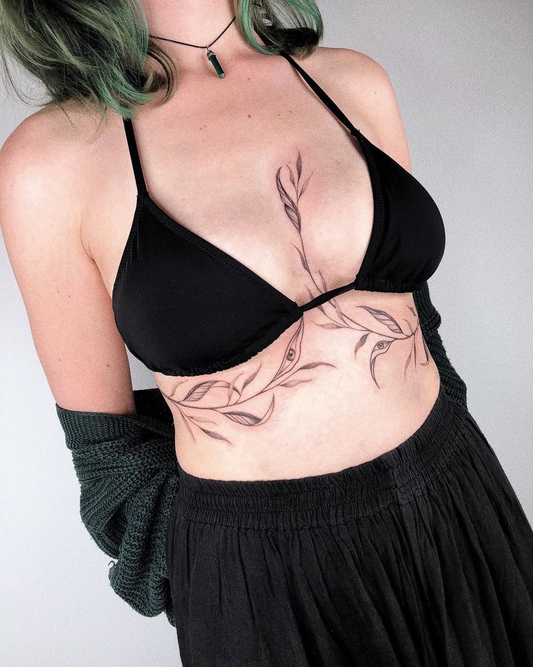 Stylish underboob tattoo featuring floral motifs Tattoo Design