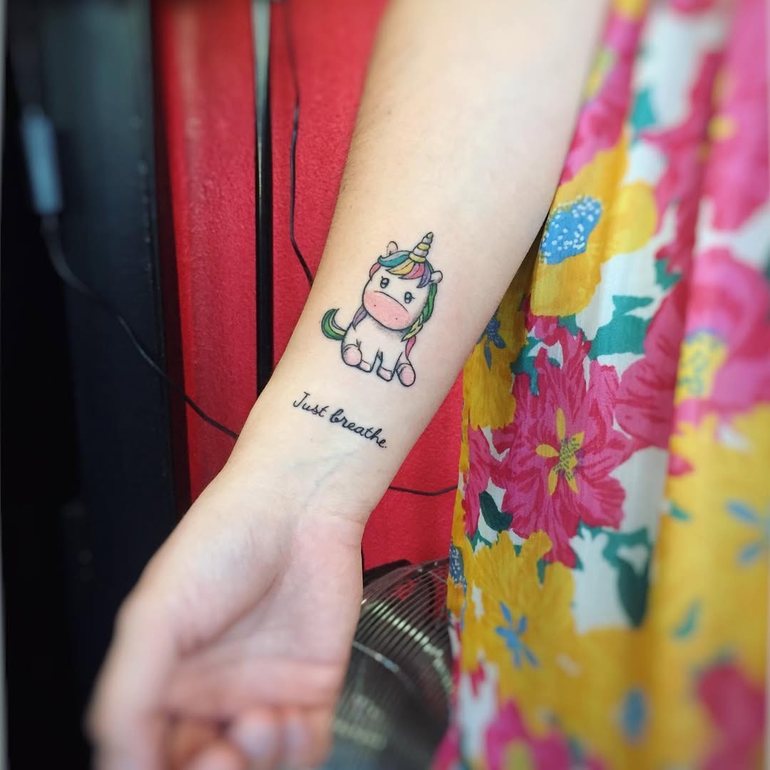 Charming unicorn tattoo with vibrant floral elements Tattoo Design