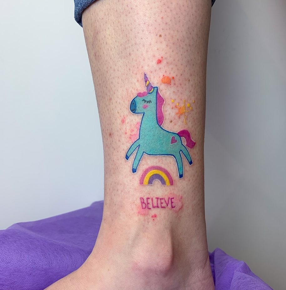 Colorful unicorn tattoo with a rainbow vibe Tattoo Design