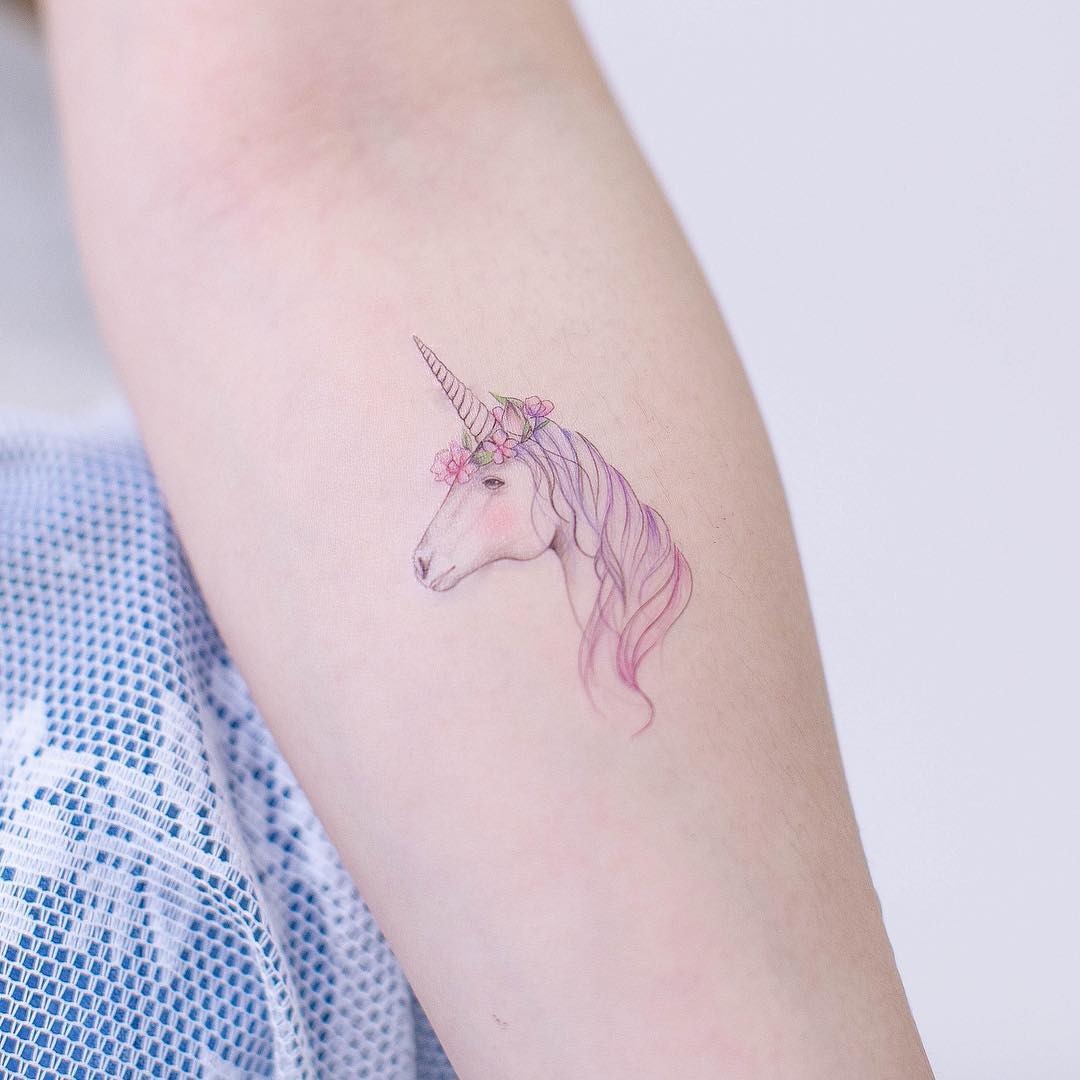 Delicate unicorn tattoo with floral accents Tattoo Design