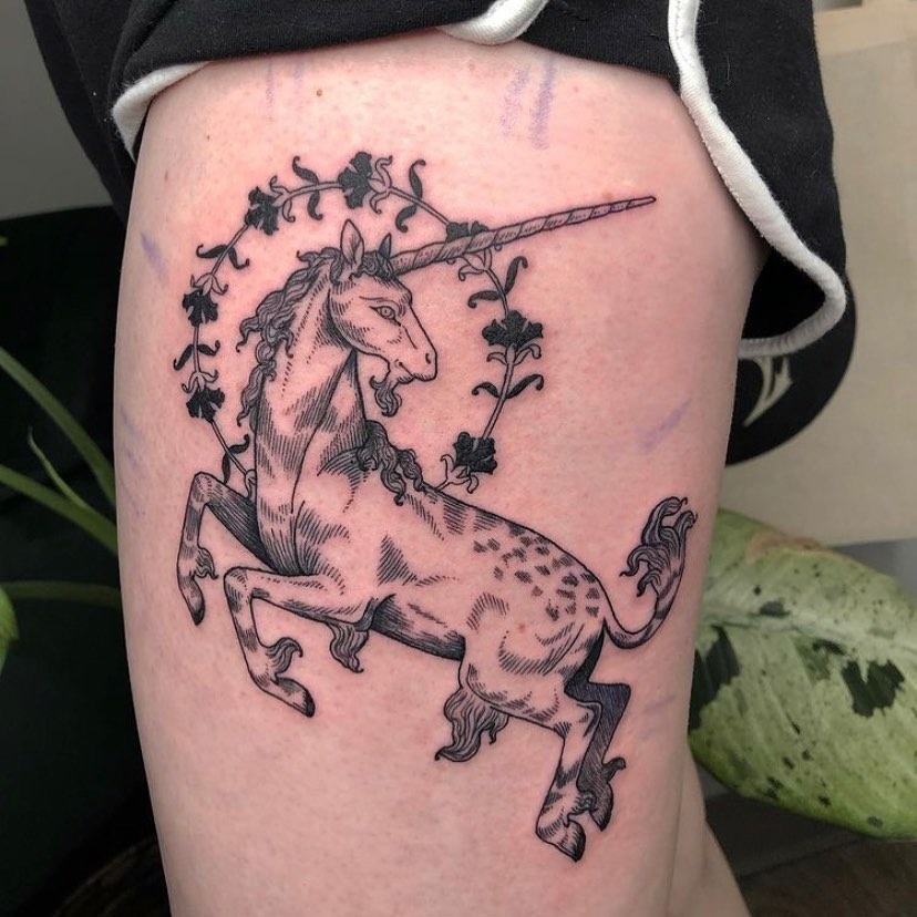 Elegant Unicorn Tattoo with Floral Accents Tattoo Design