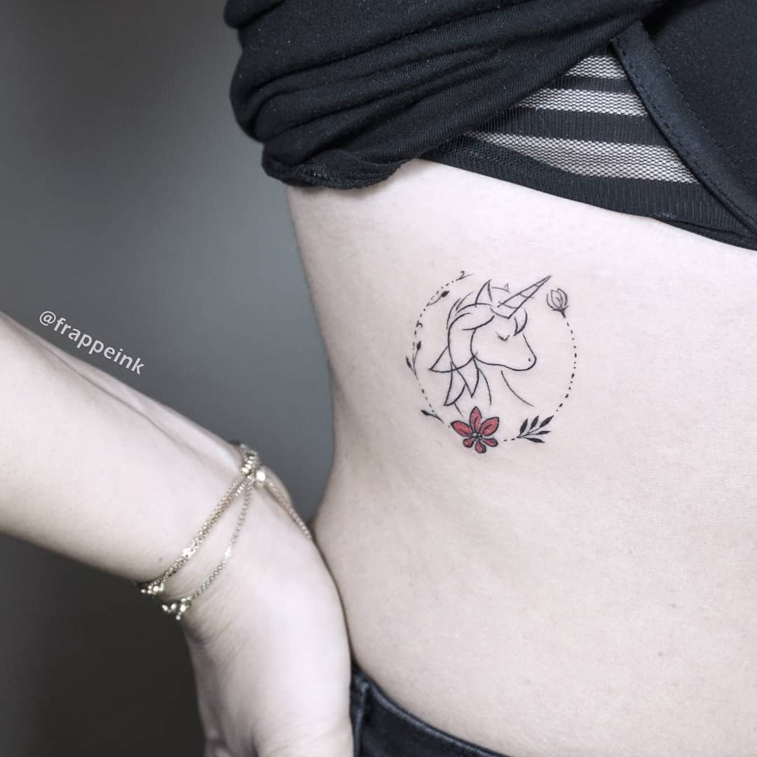 Elegant unicorn tattoo with floral accents Tattoo Design