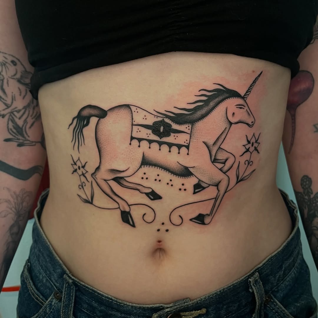 Stunning unicorn belly tattoo captures fantasy essence Tattoo Design