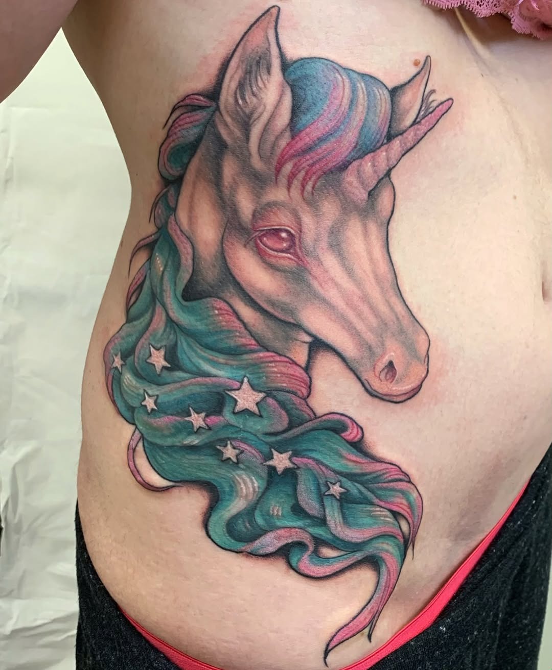 Whimsical unicorn tattoo with vibrant colors Tattoo Design