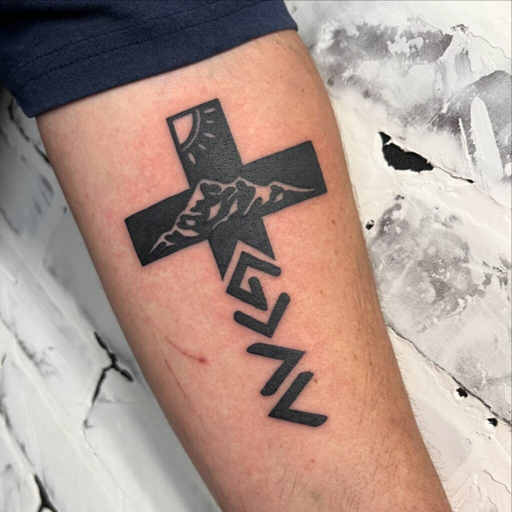 Cross, Rose, and Ascending Silhouette Forearm Tattoo Tattoo Design