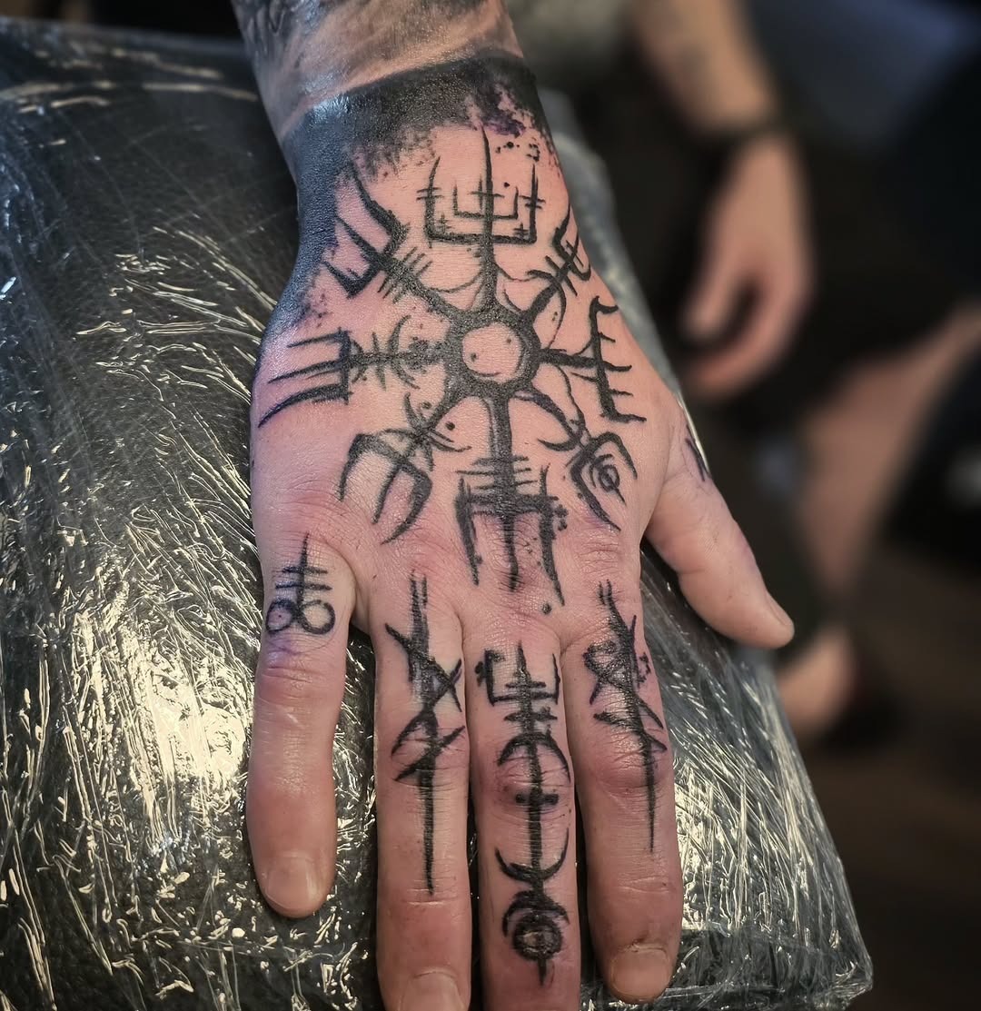Intricate Viking Symbols on Hand Tattoo Tattoo Design