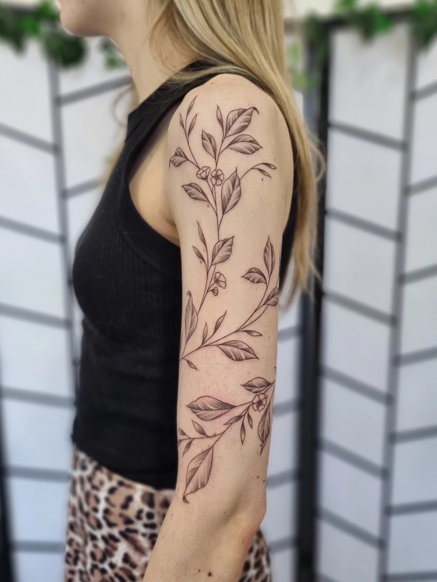 Elegant Vine Tattoo Sleeve with Leaves and Flowers Tattoo Design