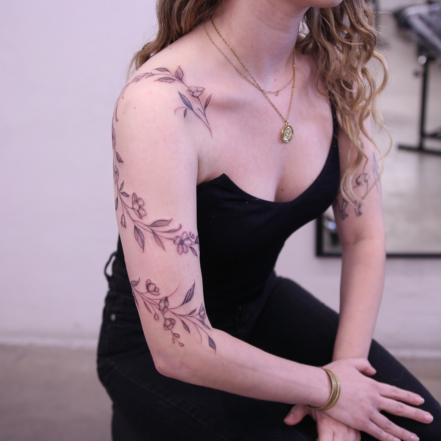 Floral Vine Tattoo Flowing Across Shoulder and Arm Tattoo Design