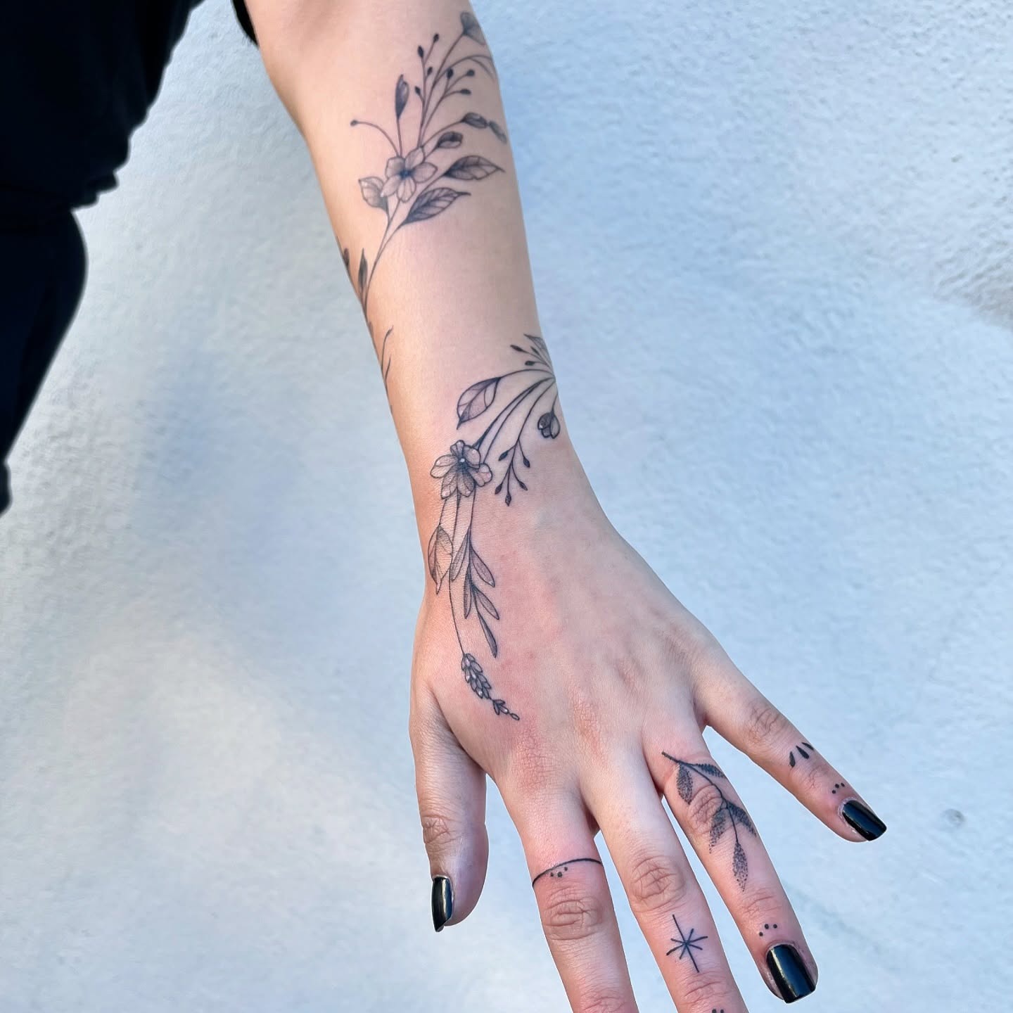 Floral Vine Tattoo Flowing from Forearm to Hand Tattoo Design