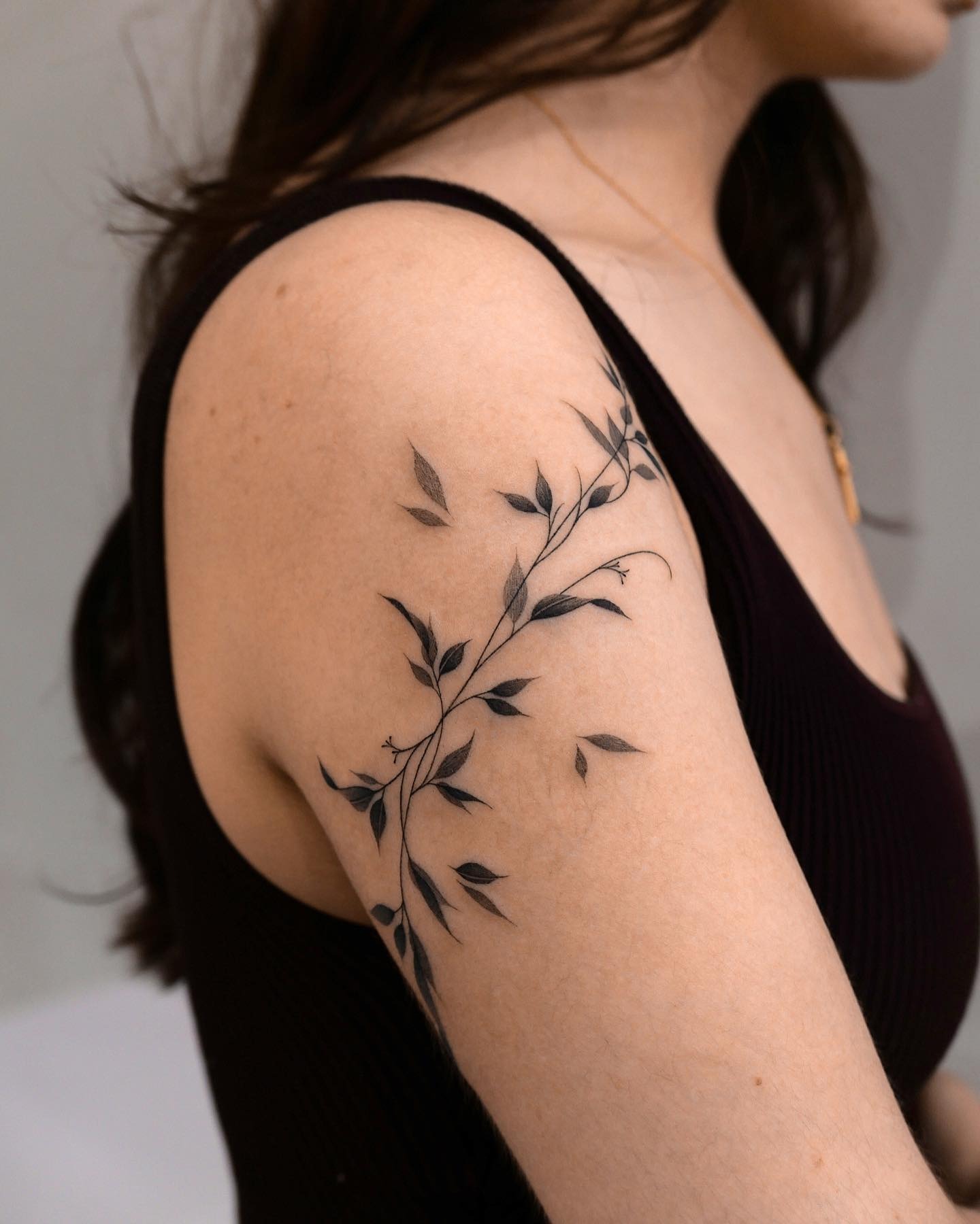 Graceful Vine Tattoo on Upper Arm Tattoo Design