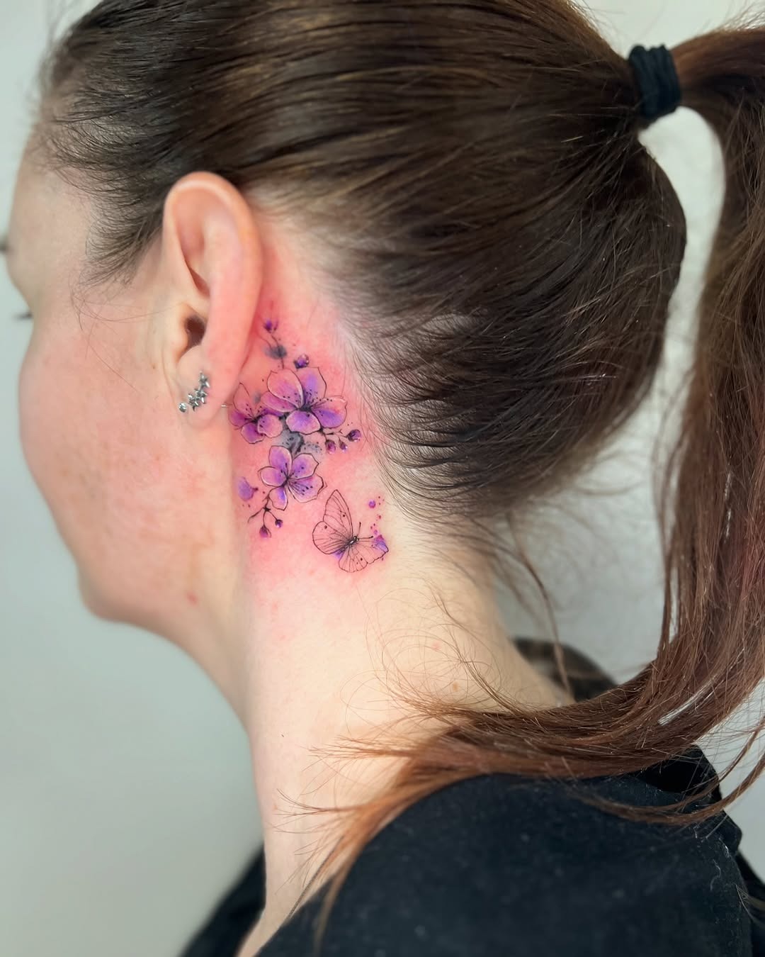 Beautiful violet floral tattoo with butterfly details Tattoo Design