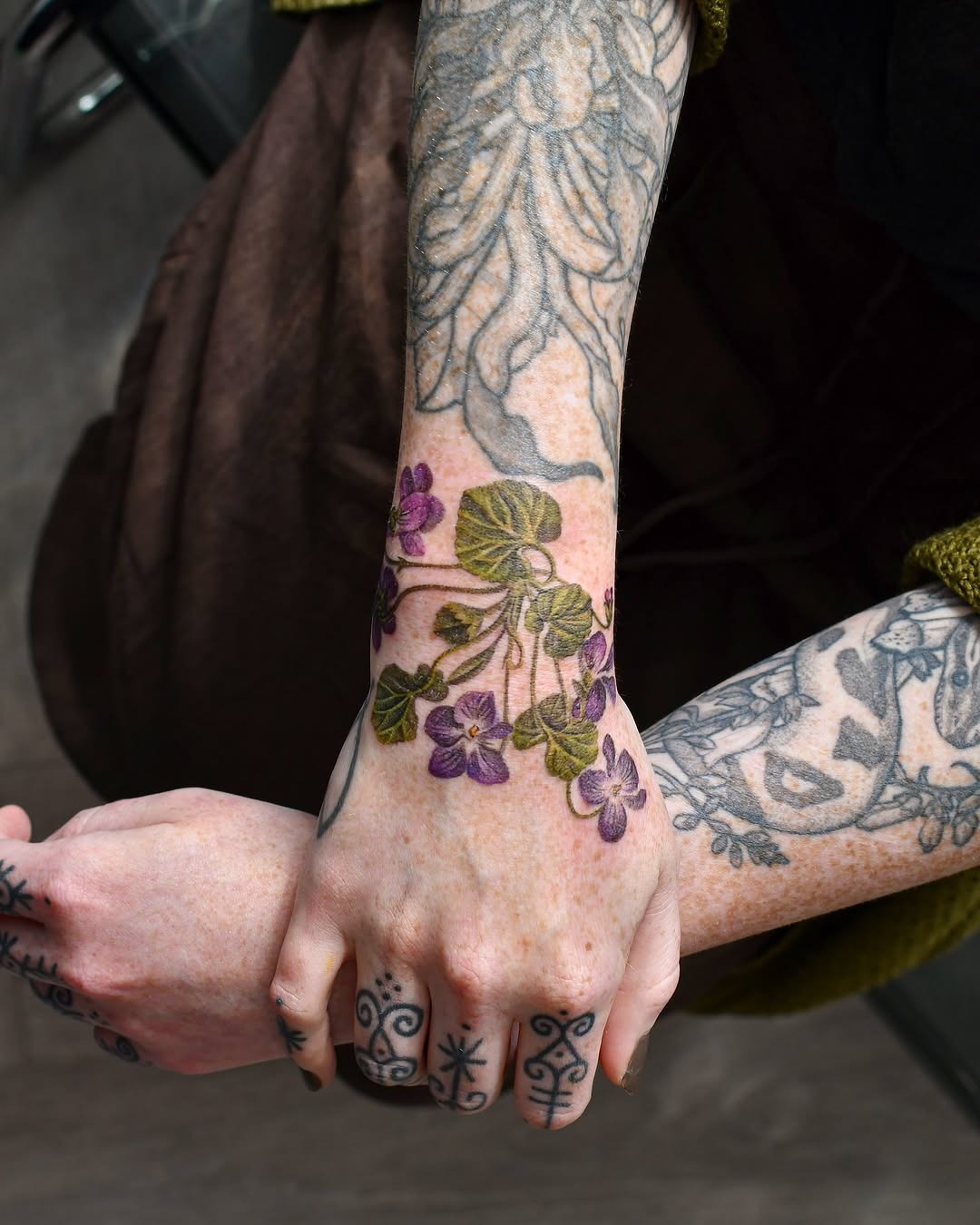 Beautiful violet tattoo details on hand and arm Tattoo Design