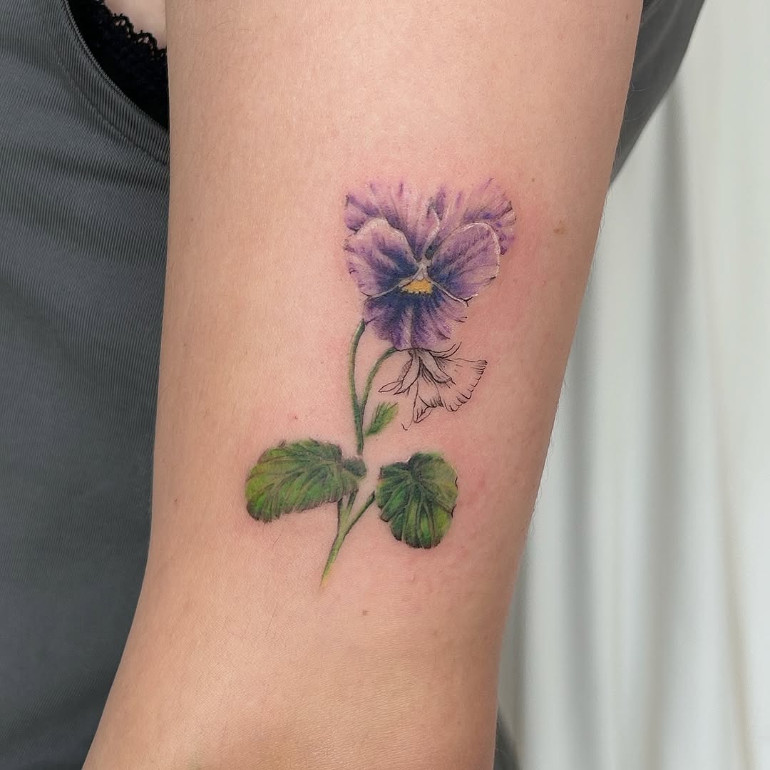 Delicate pansy tattoo showcasing vibrant violet hues Tattoo Design