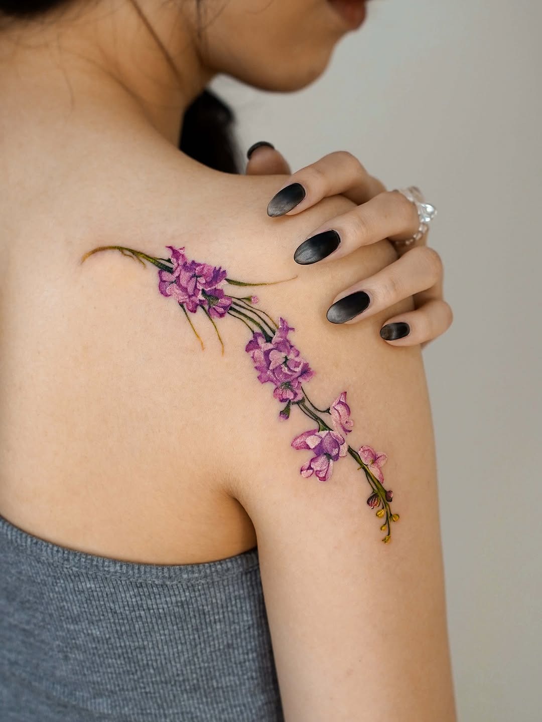 Delicate violet flower tattoo on shoulder. Tattoo Design