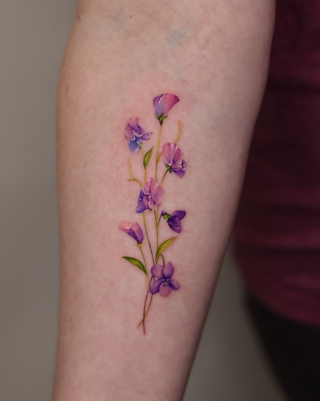 Delicate violet flower tattoo on the arm Tattoo Design