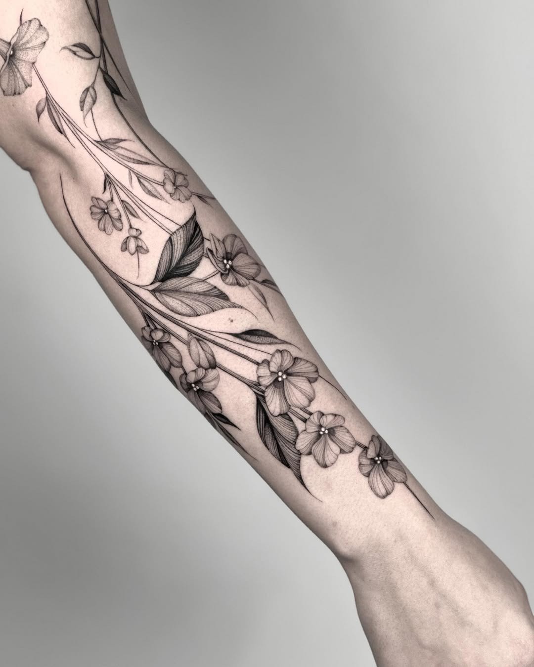 Elegant violet floral tattoo design on forearm Tattoo Design