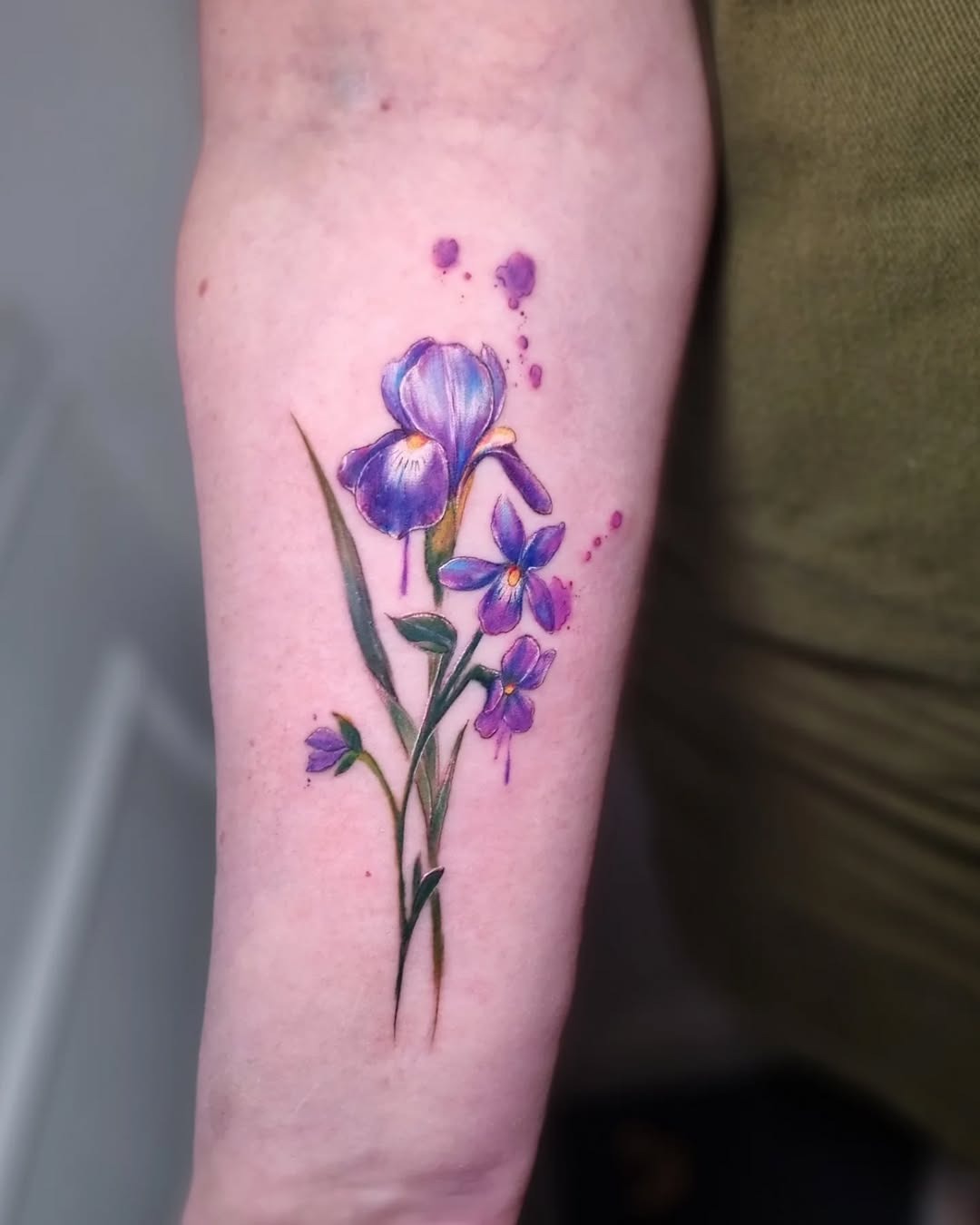 Elegant violet floral tattoo on arm Tattoo Design