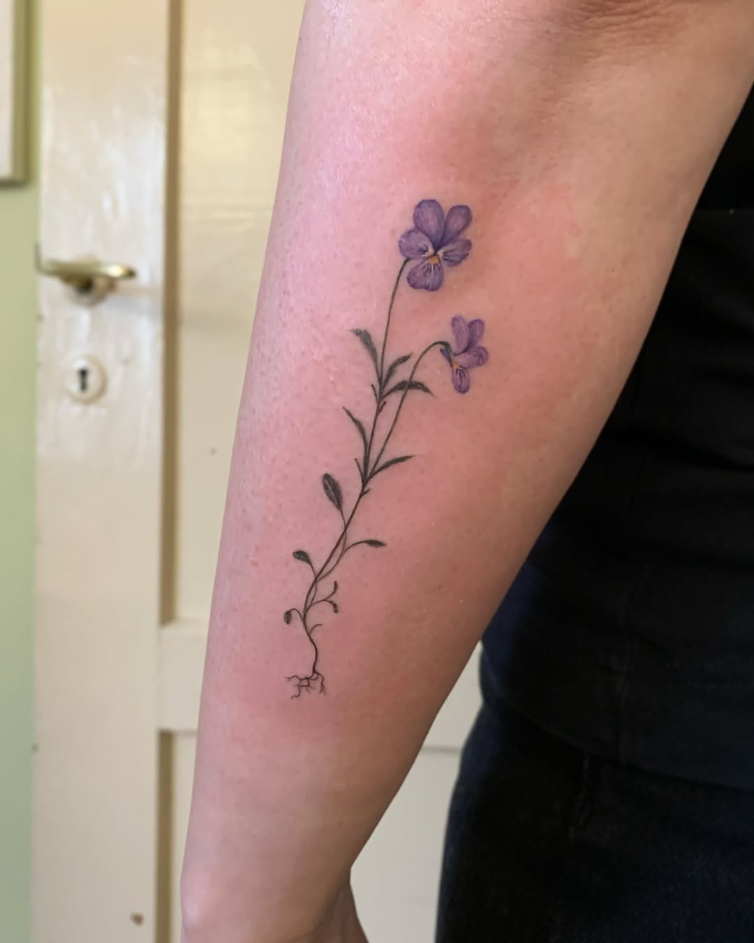 Elegant violet floral tattoo on the forearm Tattoo Design