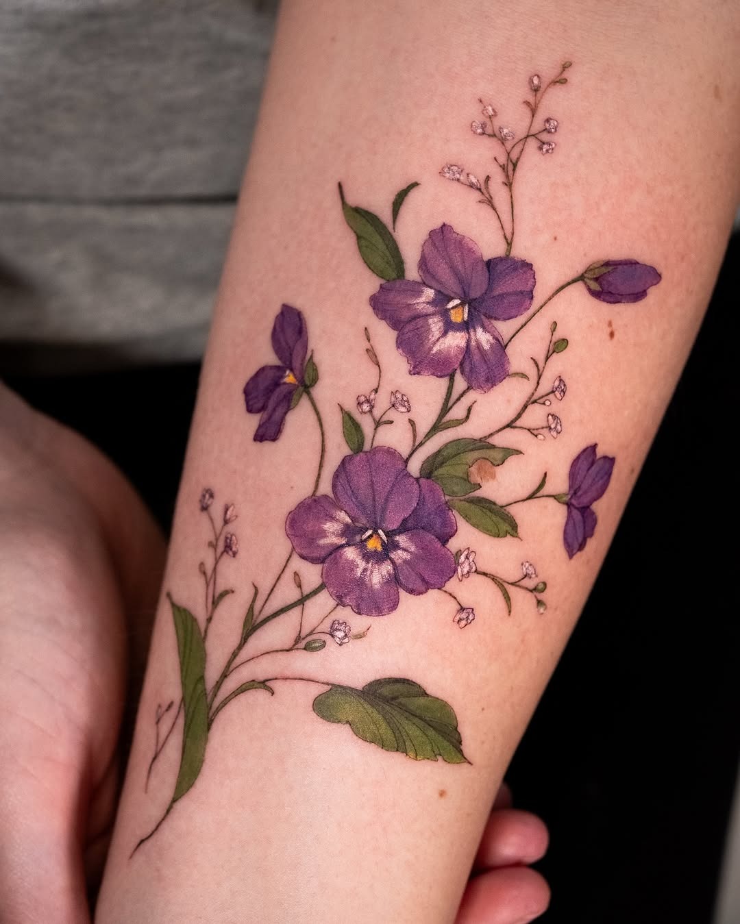 Elegant violet floral tattoo on the forearm Tattoo Design