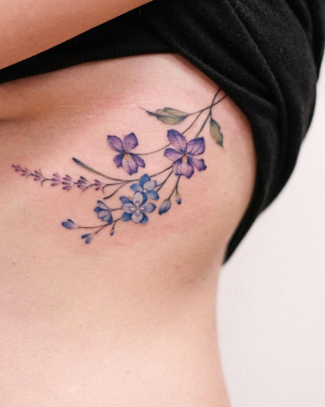 Elegant violet floral tattoo on the ribs Tattoo Design