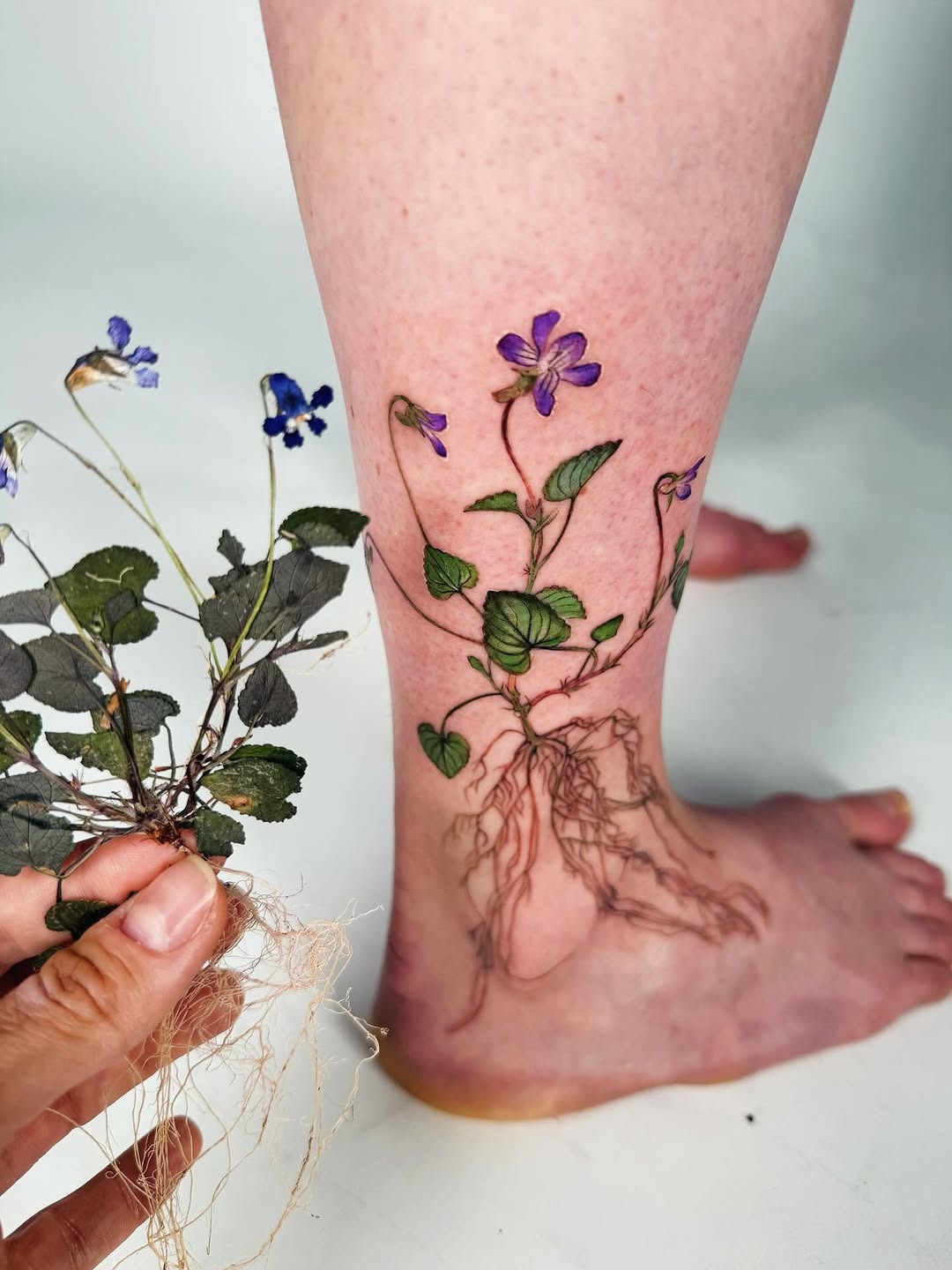 Elegant violet floral tattoo with roots Tattoo Design