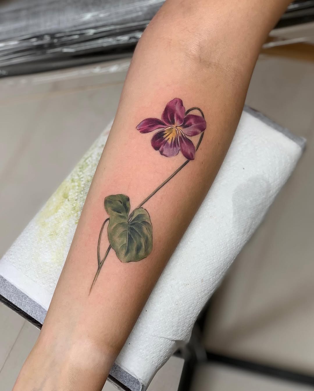 Elegant violet flower tattoo on forearm Tattoo Design