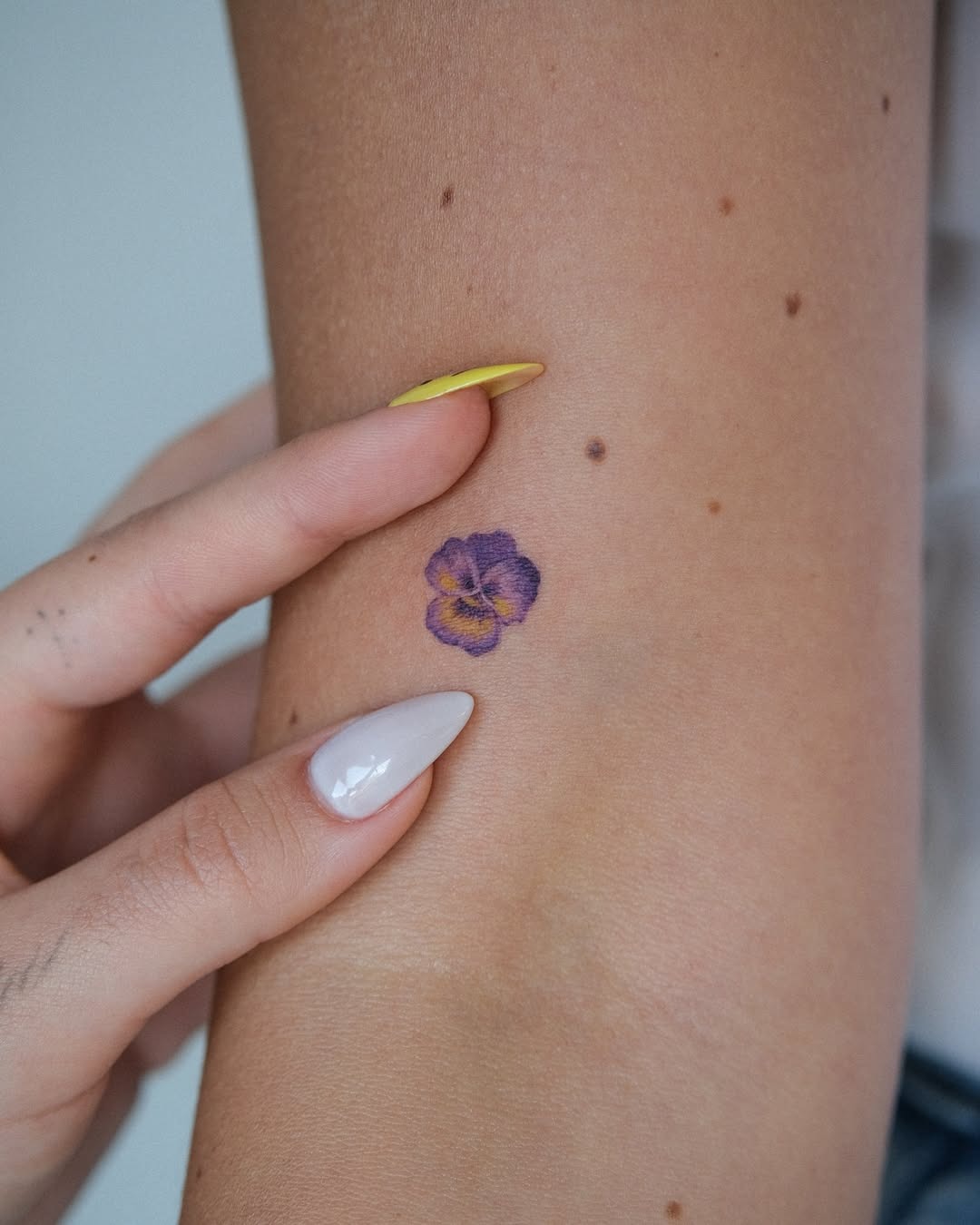 Elegant violet pansy tattoo on arm Tattoo Design