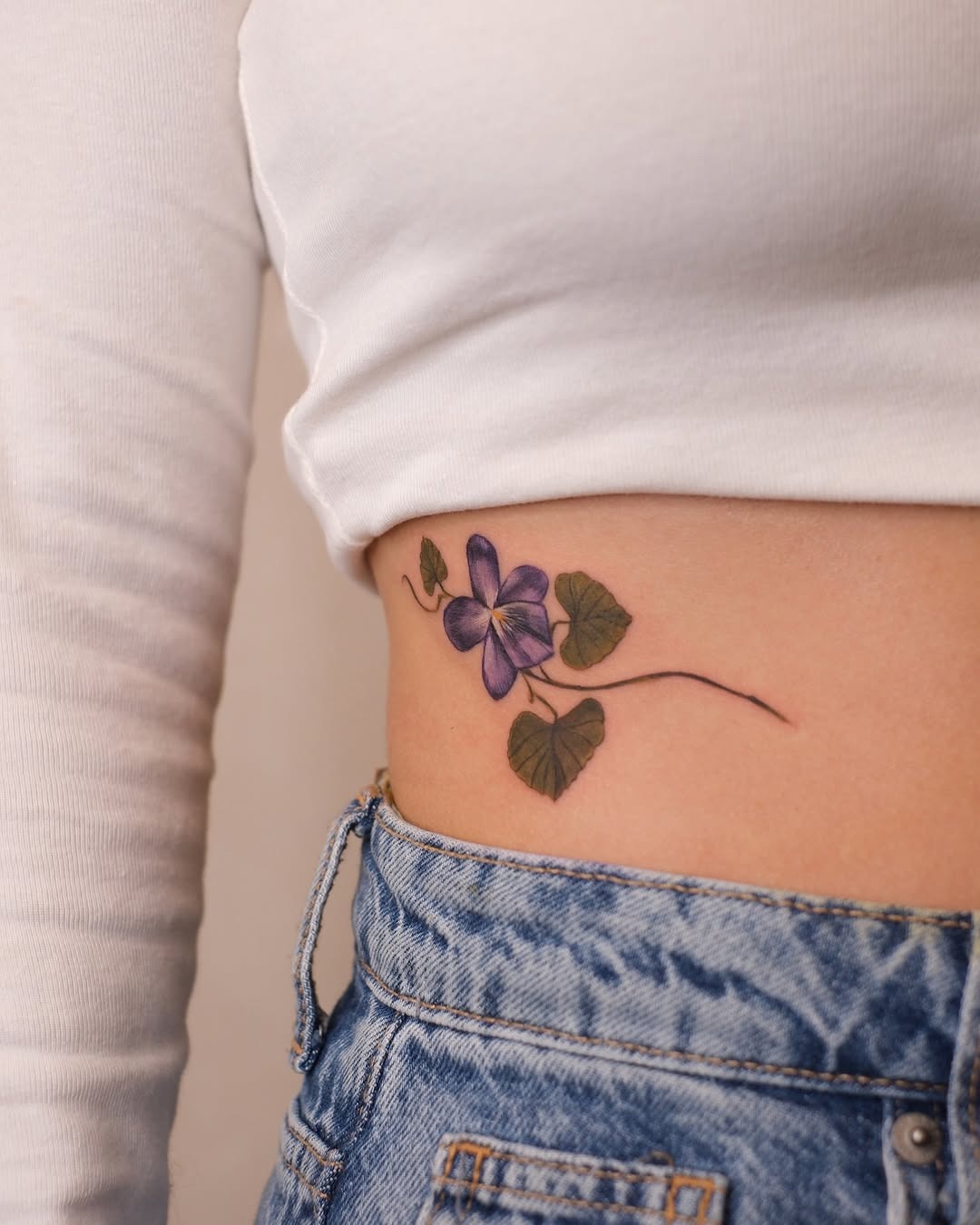 Elegant violet tattoo on the side of the body Tattoo Design