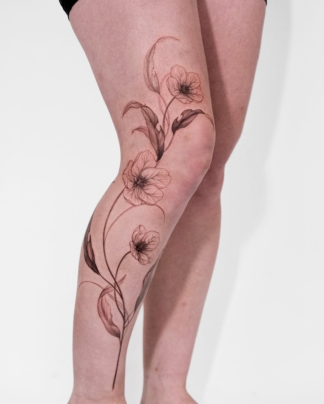 Stunning Violet Floral Tattoo on the Leg Tattoo Design