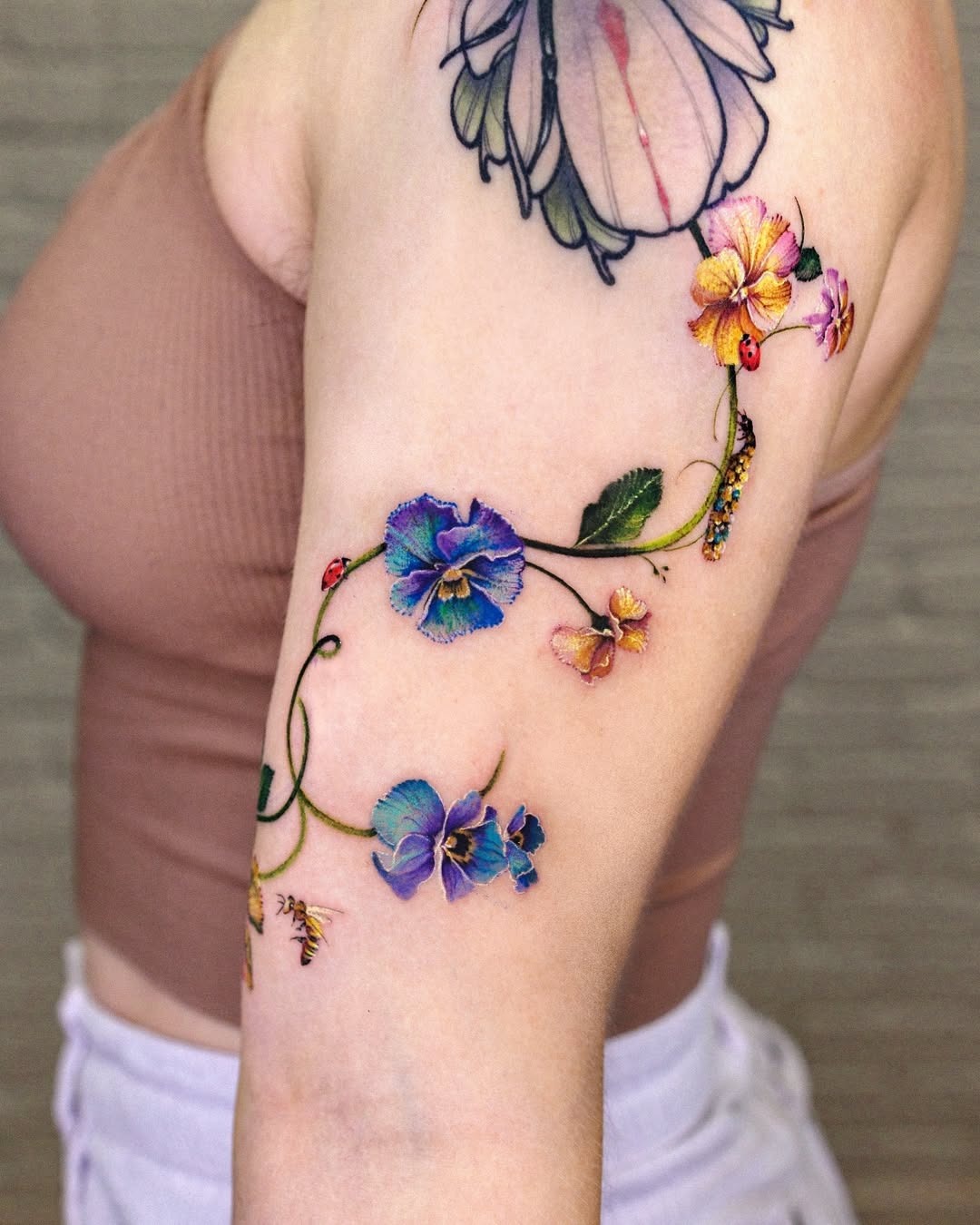 Vibrant violet floral tattoo on the arm Tattoo Design