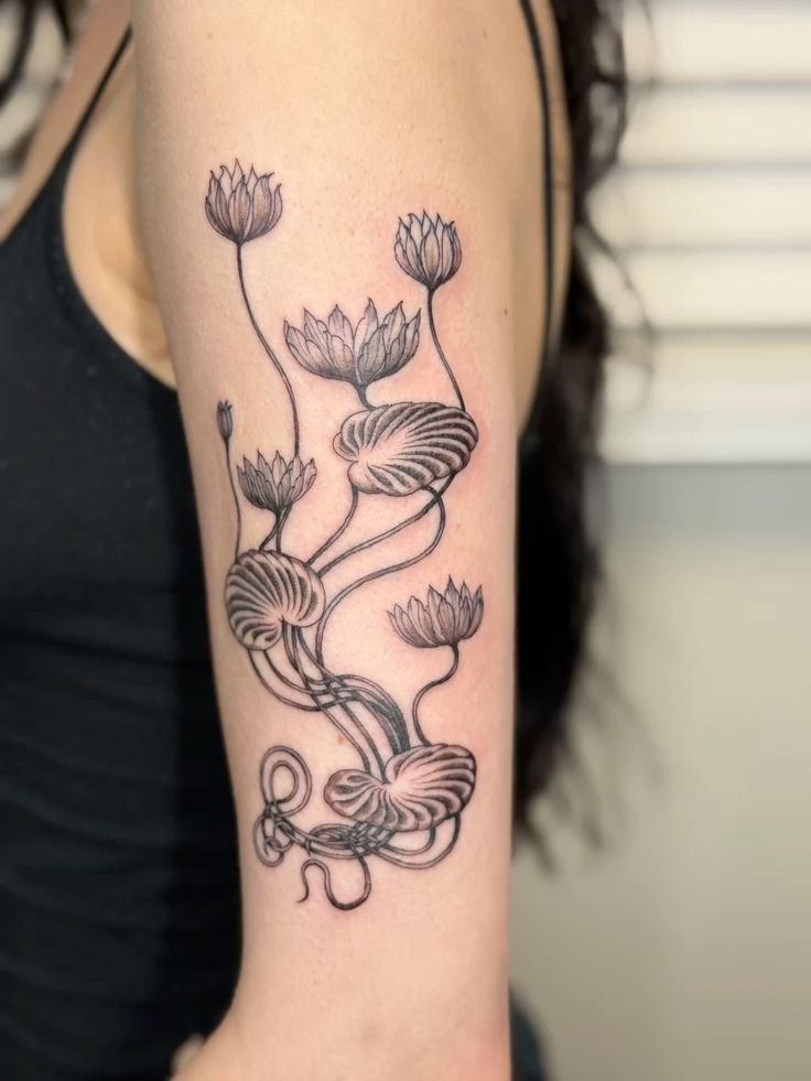 Sculptural Water Lilies with Curving Stems Tattoo Design