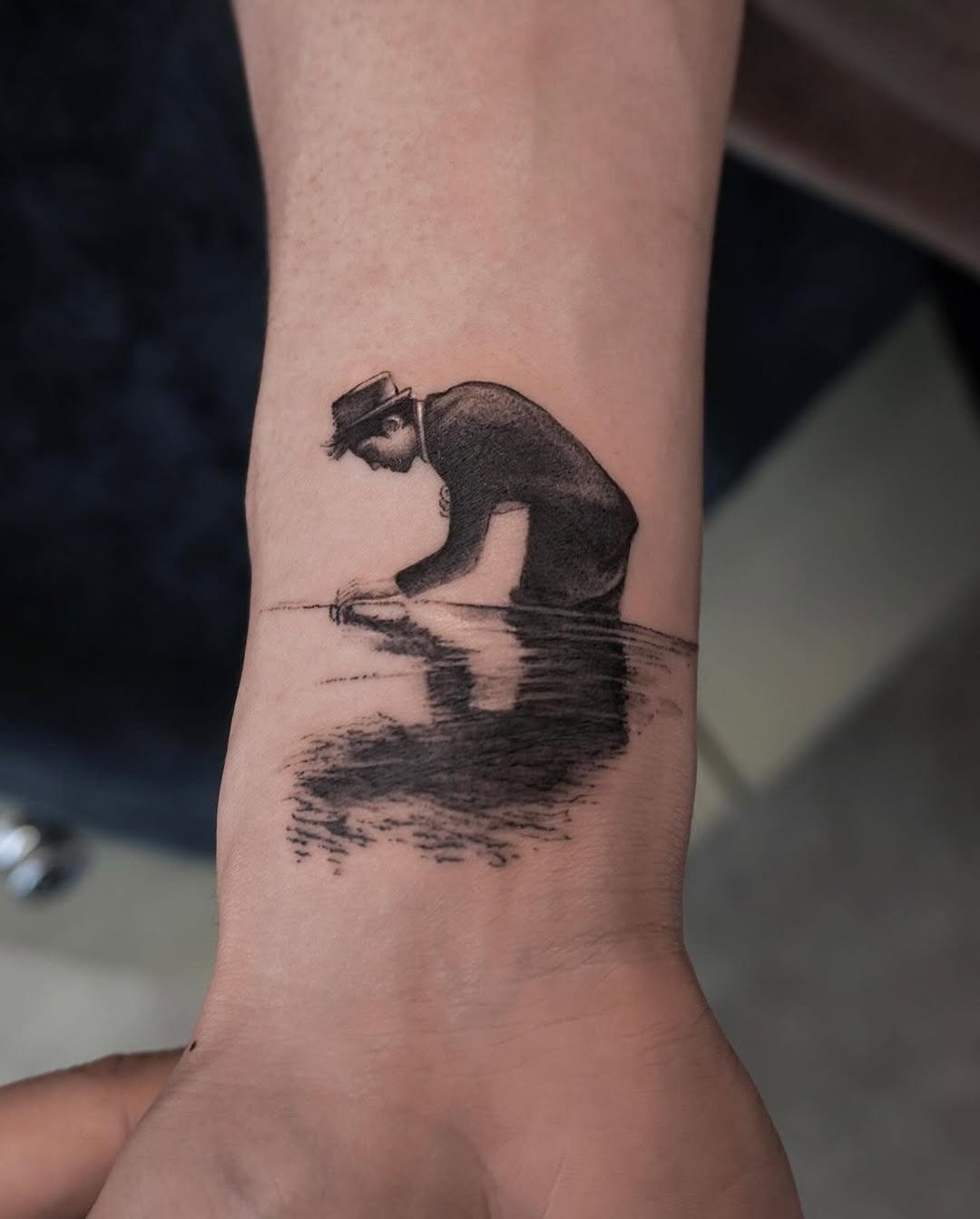 Artistic tattoo of man interacting with water Tattoo Design