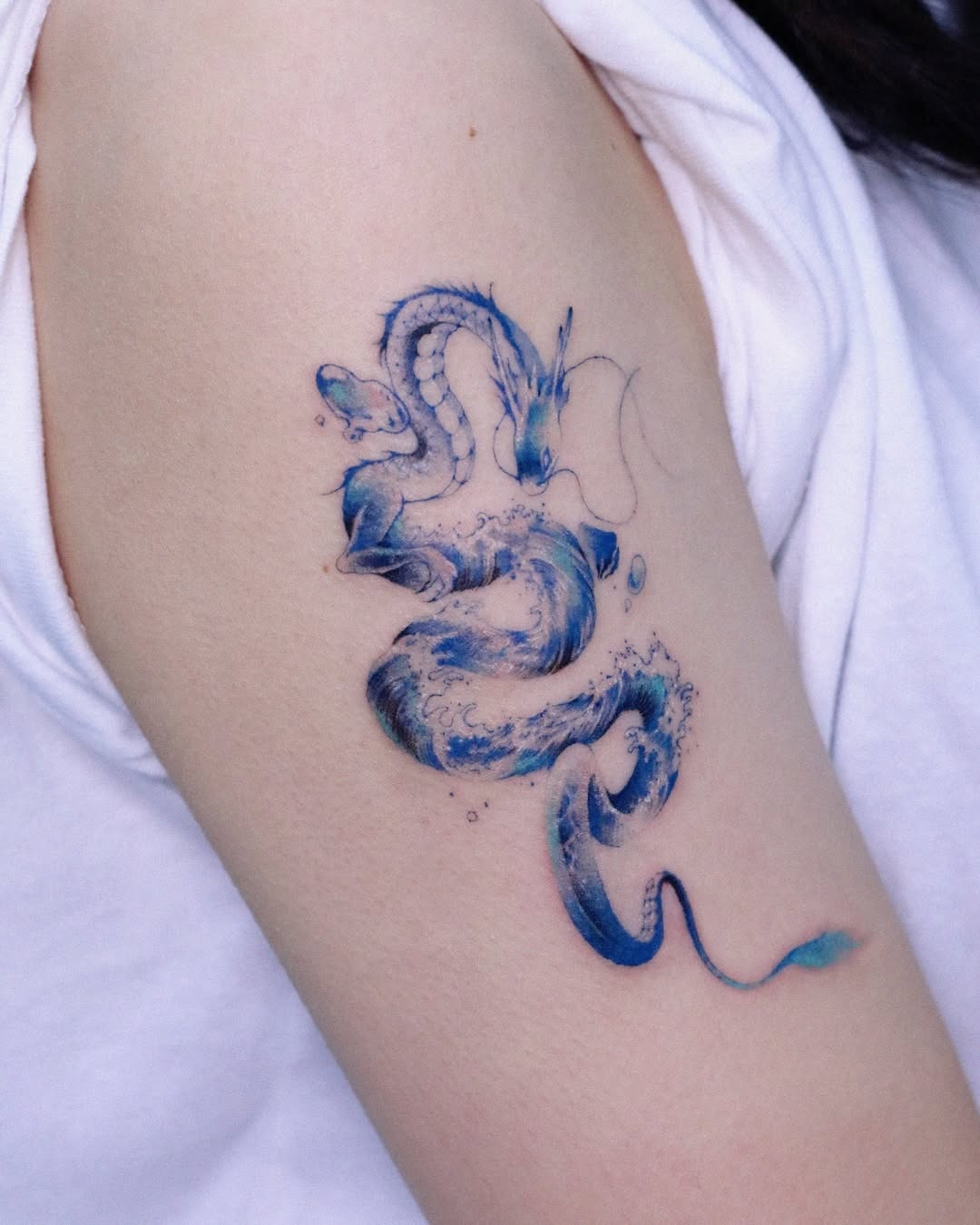 Breathtaking water dragon tattoo in vibrant blues Tattoo Design