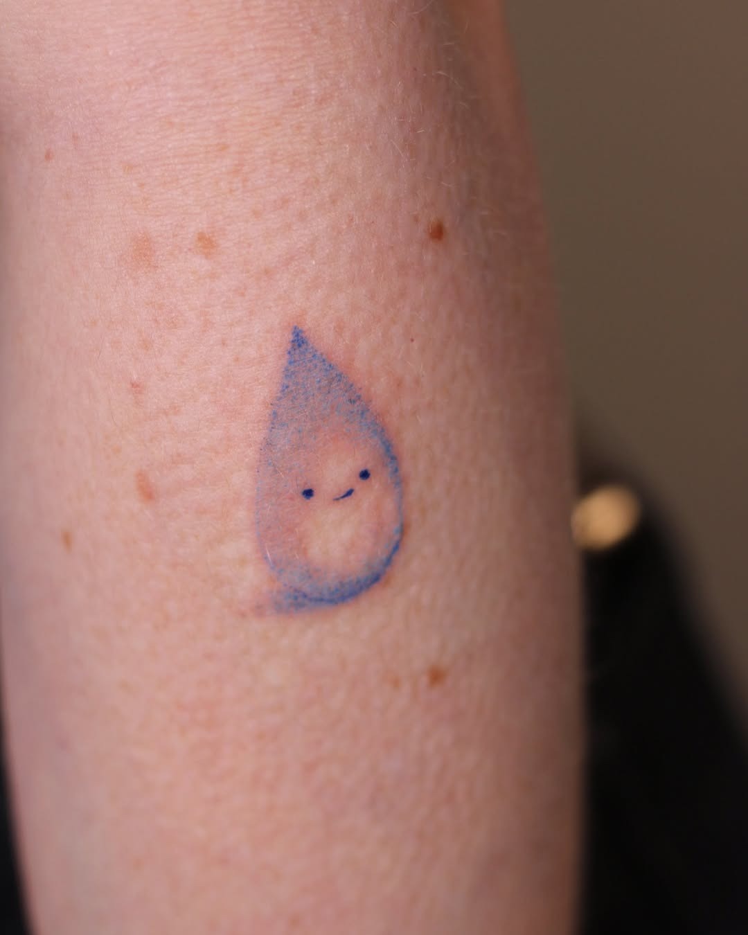 Charming water drop tattoo with a smile Tattoo Design