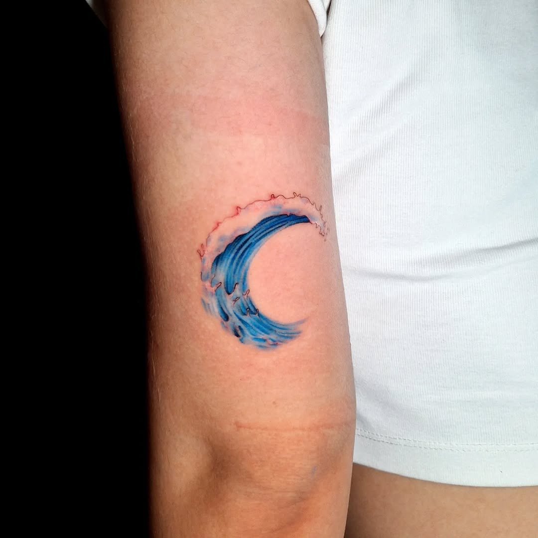 Dynamic blue wave tattoo on the arm Tattoo Design